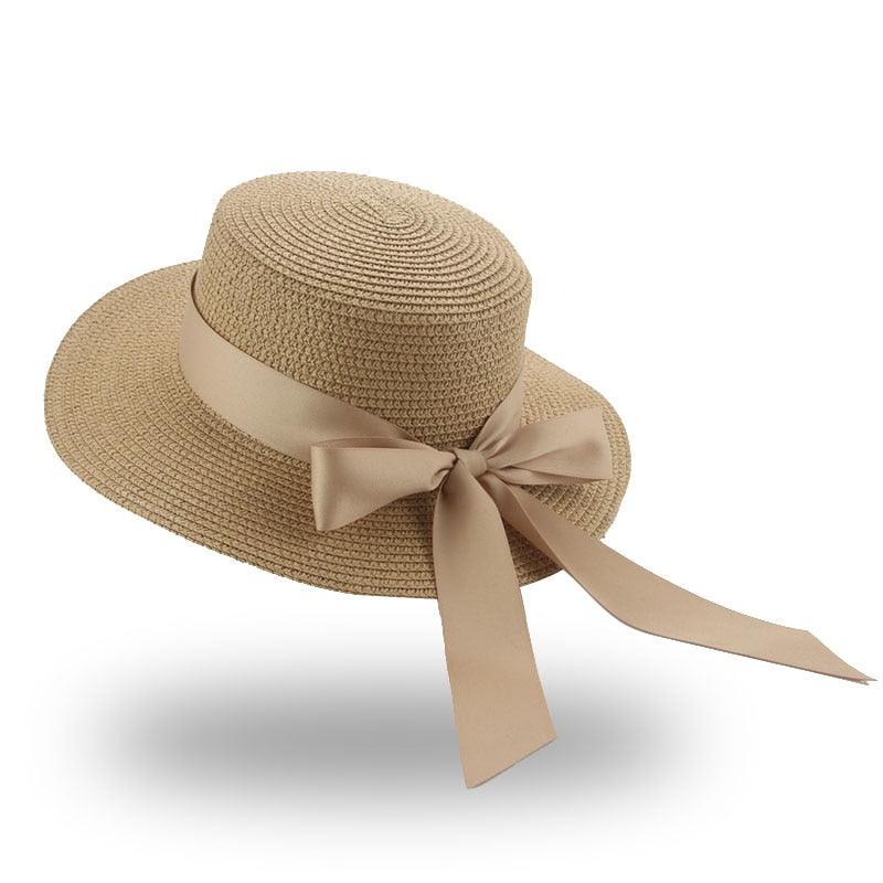 Elegant women's straw bucket hat with ribbon bowknot in beige and black