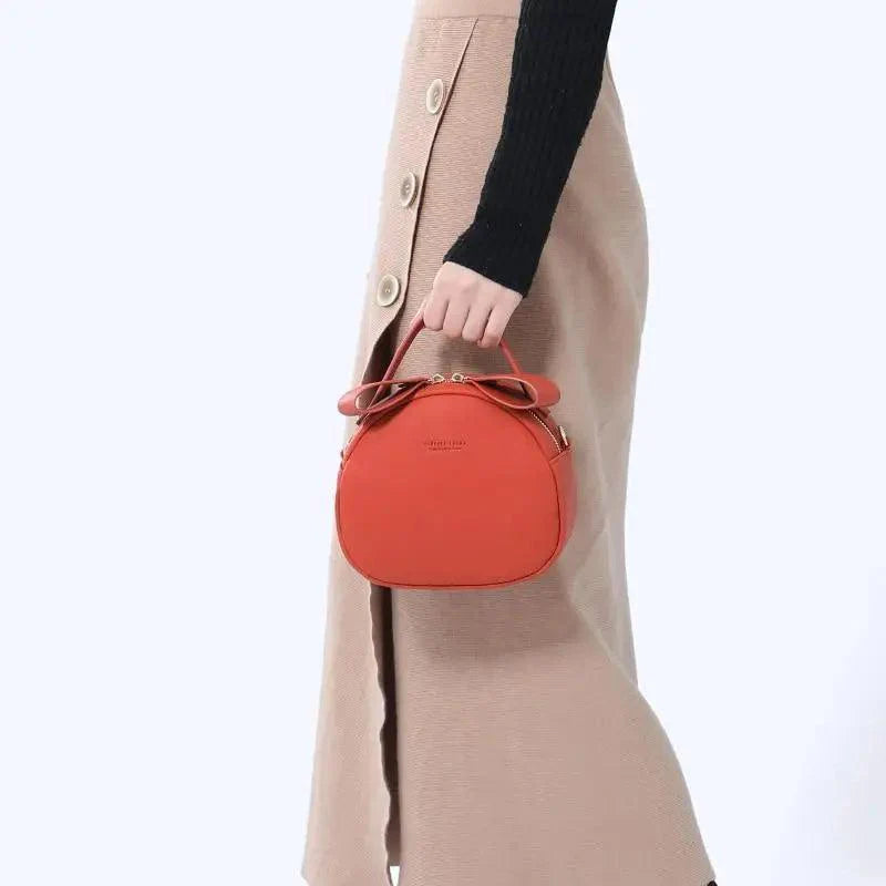 Elegant geometric round women's crossbody bag in soft PU leather with adjustable shoulder strap