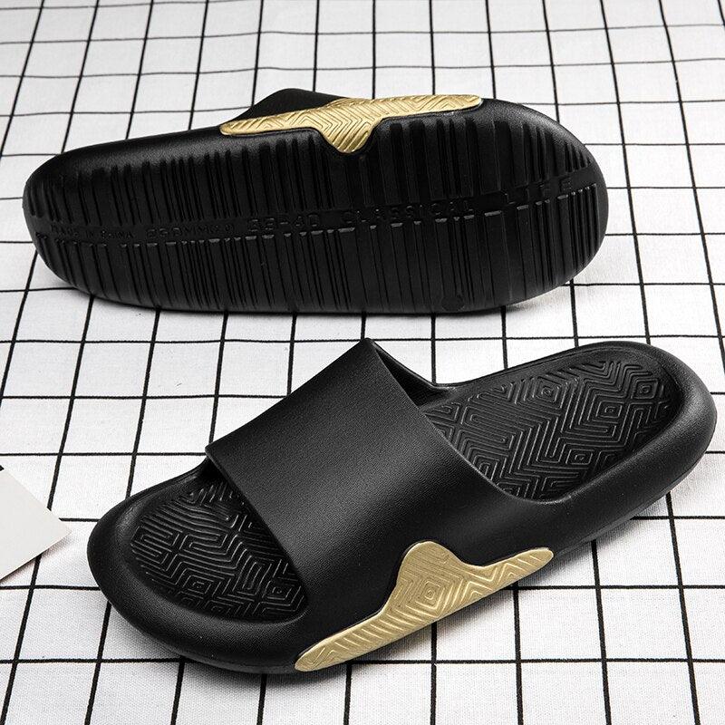 A pair of black ergonomic EVA foam slides shown from a side profile highlighting the thick sole and arch support.