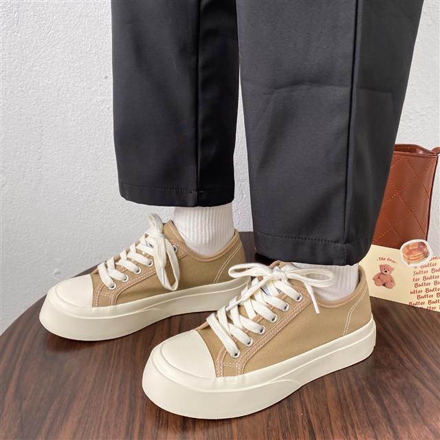 Women's white low top canvas platform sneakers with lace-up closure