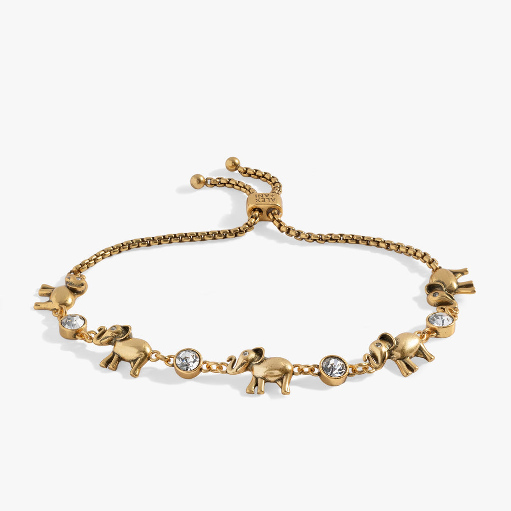 Adjustable gold and silver tone bolo bracelet with elephant charms and crystal accents