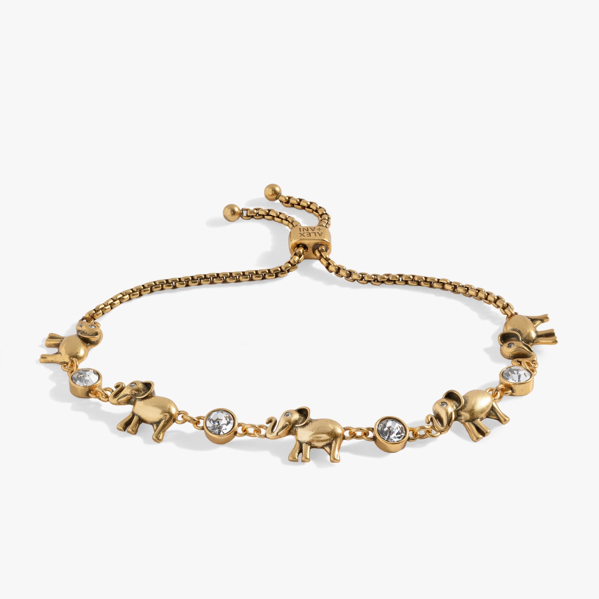 Adjustable gold and silver tone bolo bracelet with elephant charms and crystal accents