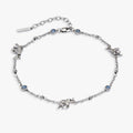 Silver-plated anklet featuring elephant charms and blue opal glass cabochons with a lobster clasp closure.