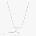 Delicate sideways letter A initial pendant necklace in gold, accented with a small cubic zirconia stone.