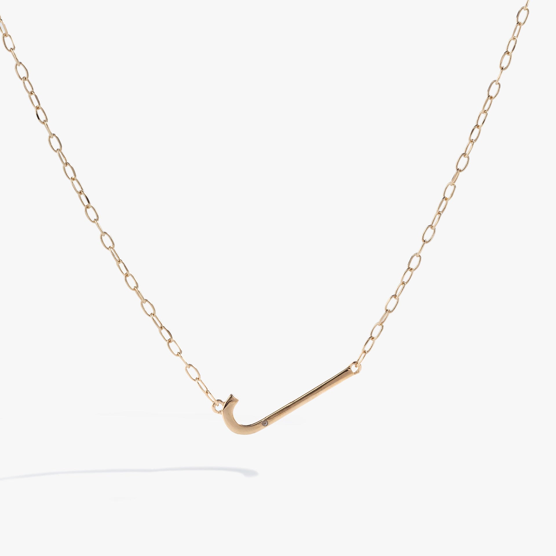 Initial J elongated pendant necklace with white CZ accent in gold vermeil on a delicate chain