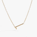 Minimalist sideways letter L necklace in metallic gold tone on a delicate chain