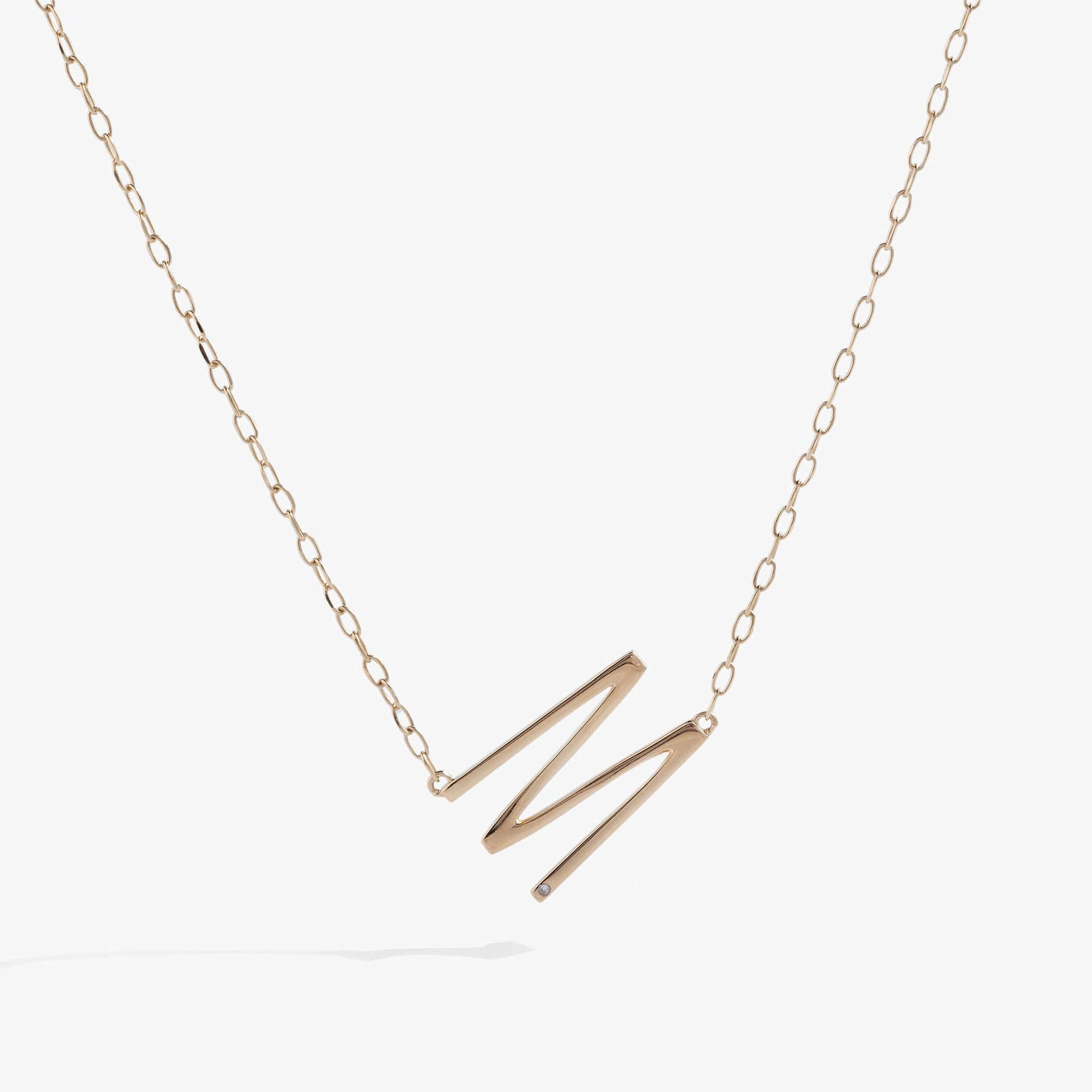 Sideways initial M pendant necklace in 14k gold vermeil with a cubic zirconia stone