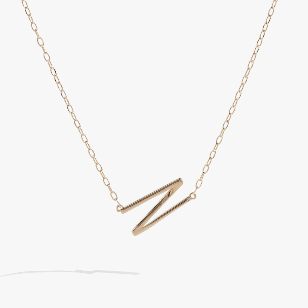 Sideways initial N pendant necklace in gold vermeil with cubic zirconia accent
