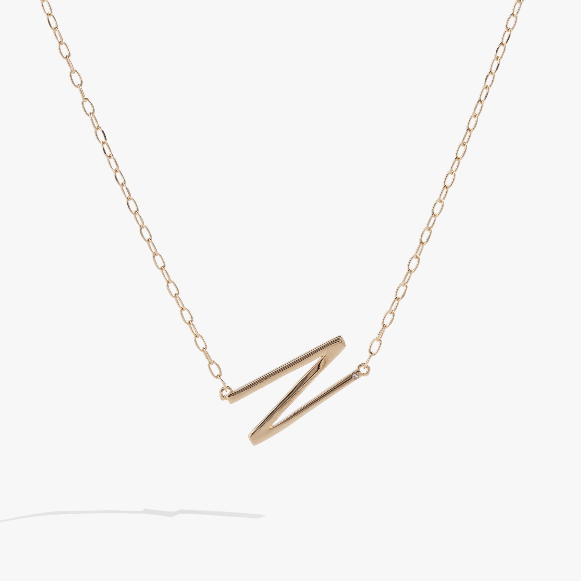 Sideways initial N pendant necklace in gold vermeil with cubic zirconia accent