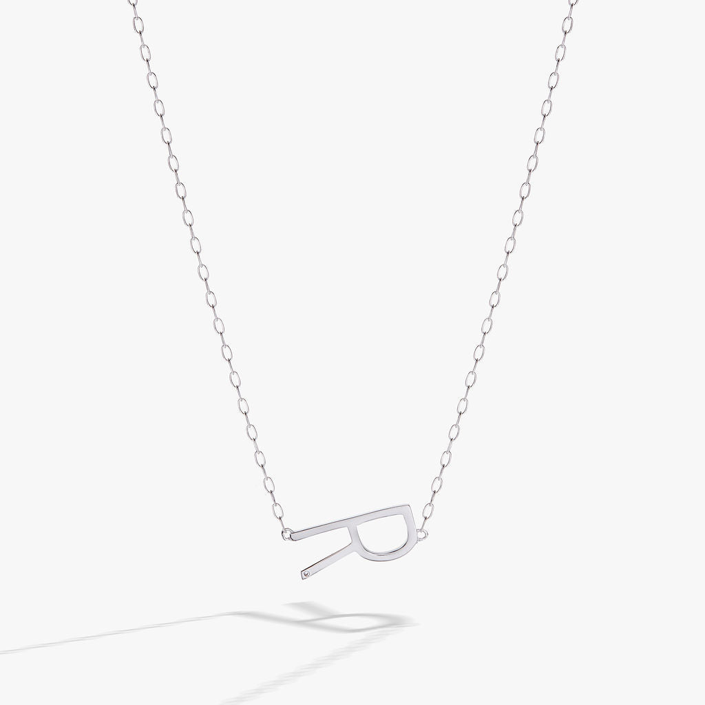 Initial R sideways pendant necklace in sterling silver with a white CZ accent