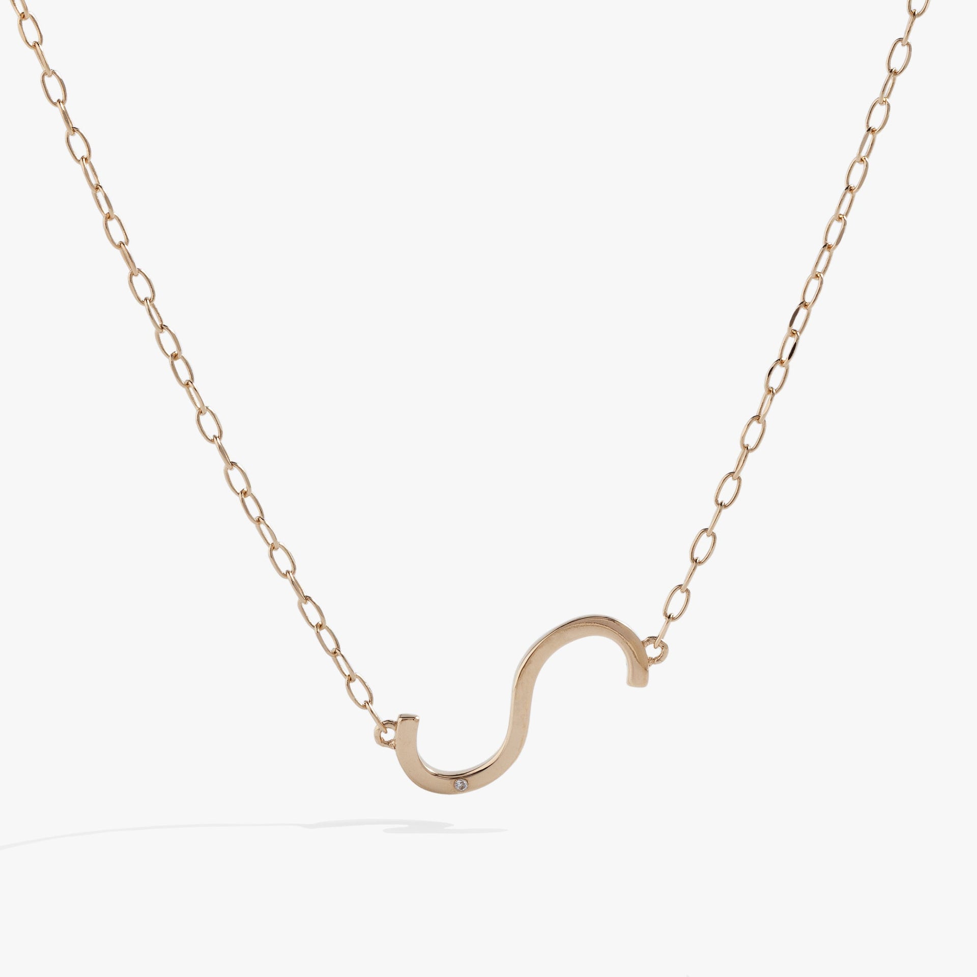 Sideways Initial S pendant necklace featuring a white CZ stone on a delicate gold chain