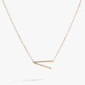 Sideways initial V pendant necklace with cubic zirconia in gold or silver.