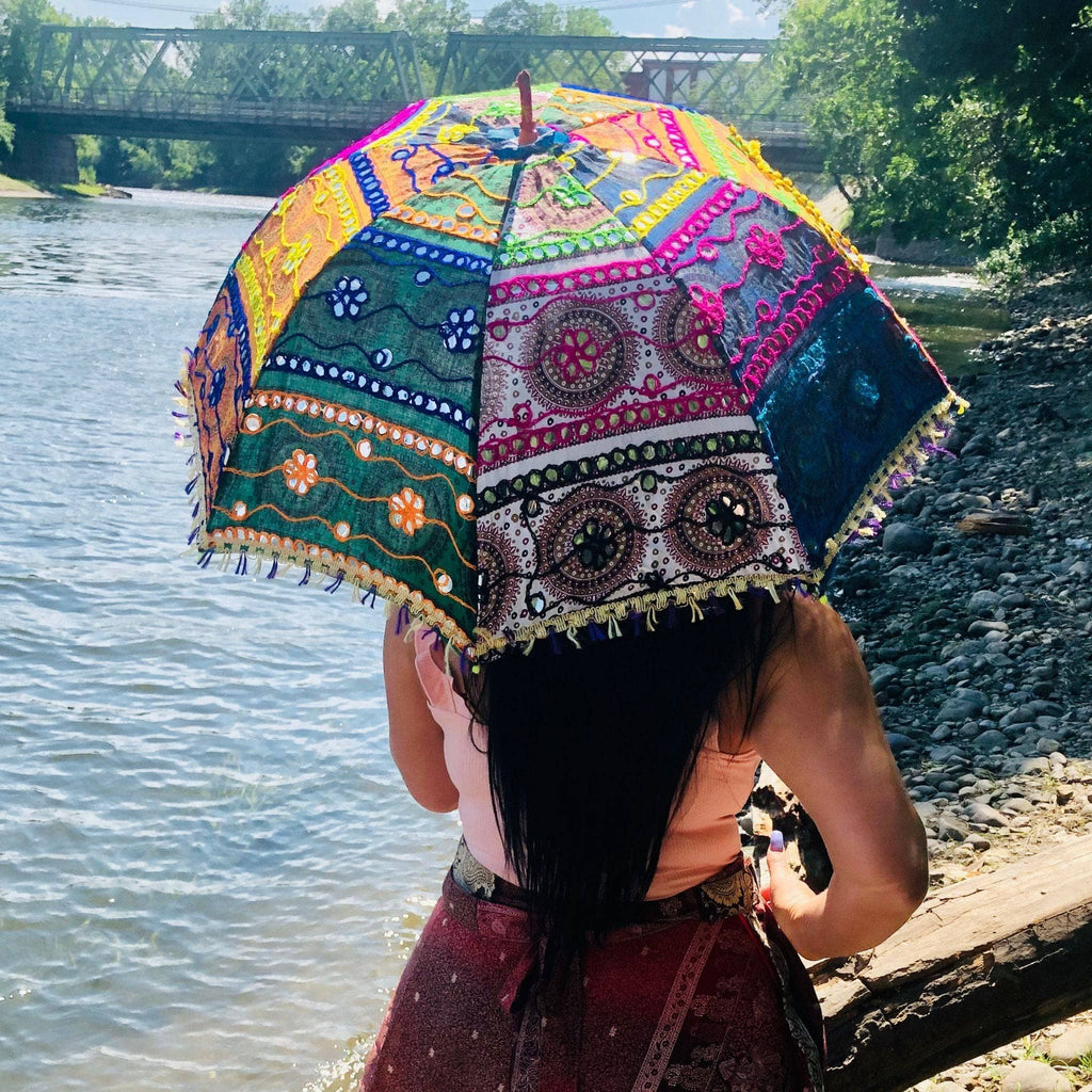 A beautiful hand-embellished parasol umbrella featuring unique decorative detailing for sun protection.