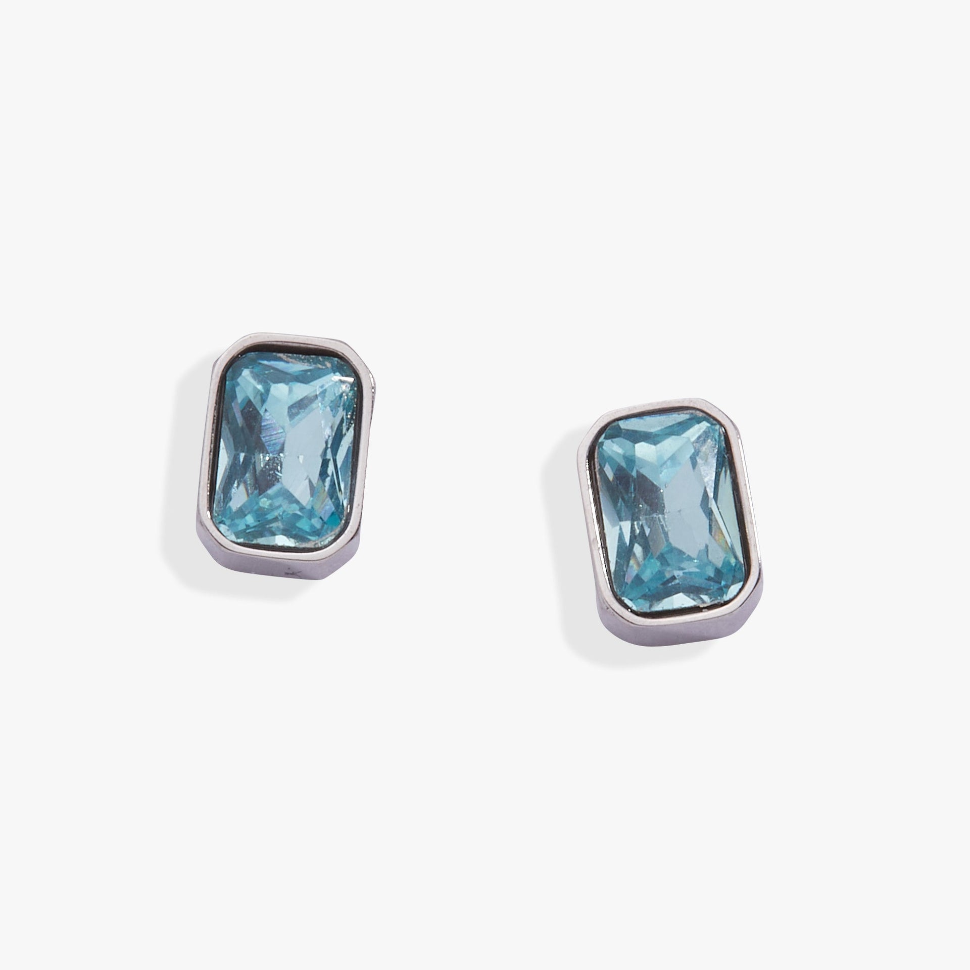 March birthstone stud earrings featuring an emerald-cut aquamarine in a bezel setting.