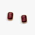 A pair of emerald-cut Siam red glass stud earrings in a polished bezel setting.