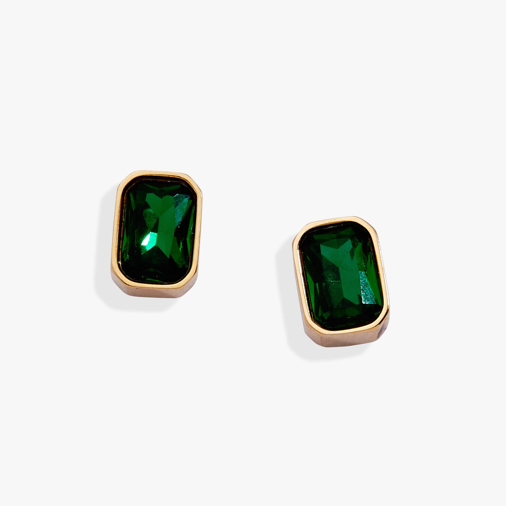 May emerald-cut birthstone stud earrings in a sleek bezel setting.