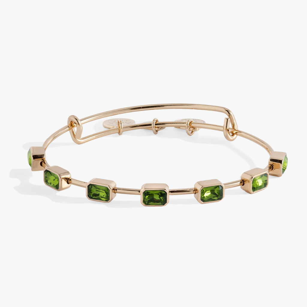 August birthstone expandable wire bangle featuring seven emerald-cut peridot green crystals
