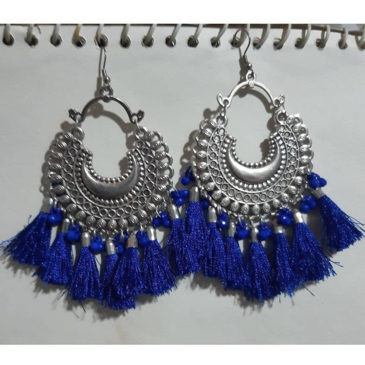 Handcrafted royal blue thread earrings with glass pearl details.