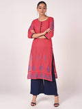 Baby wearing a pink hand block print straight kurta featuring traditional patterns.