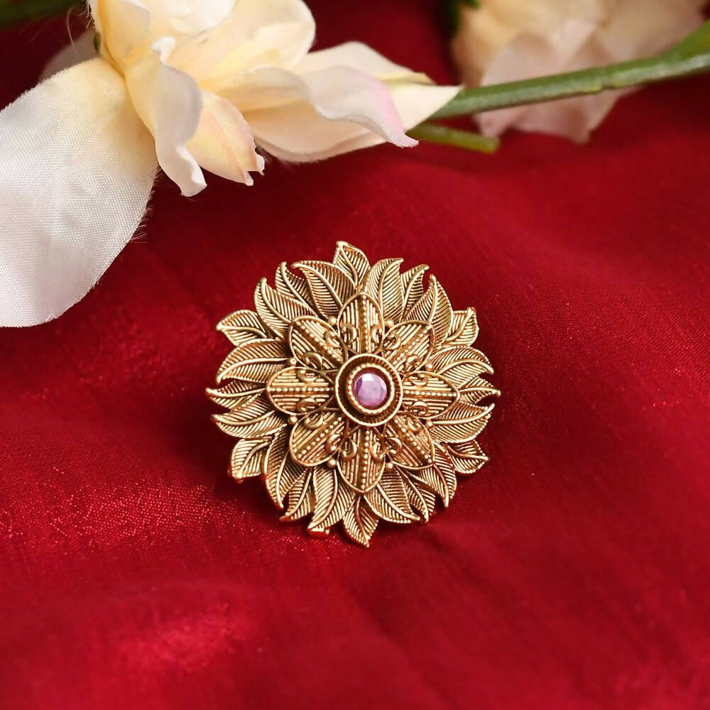 Close up of an ornate gold-polished Joharkamal ring featuring intricate stone settings.