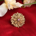 Close up of an ornate gold-polished Joharkamal ring featuring intricate stone settings.