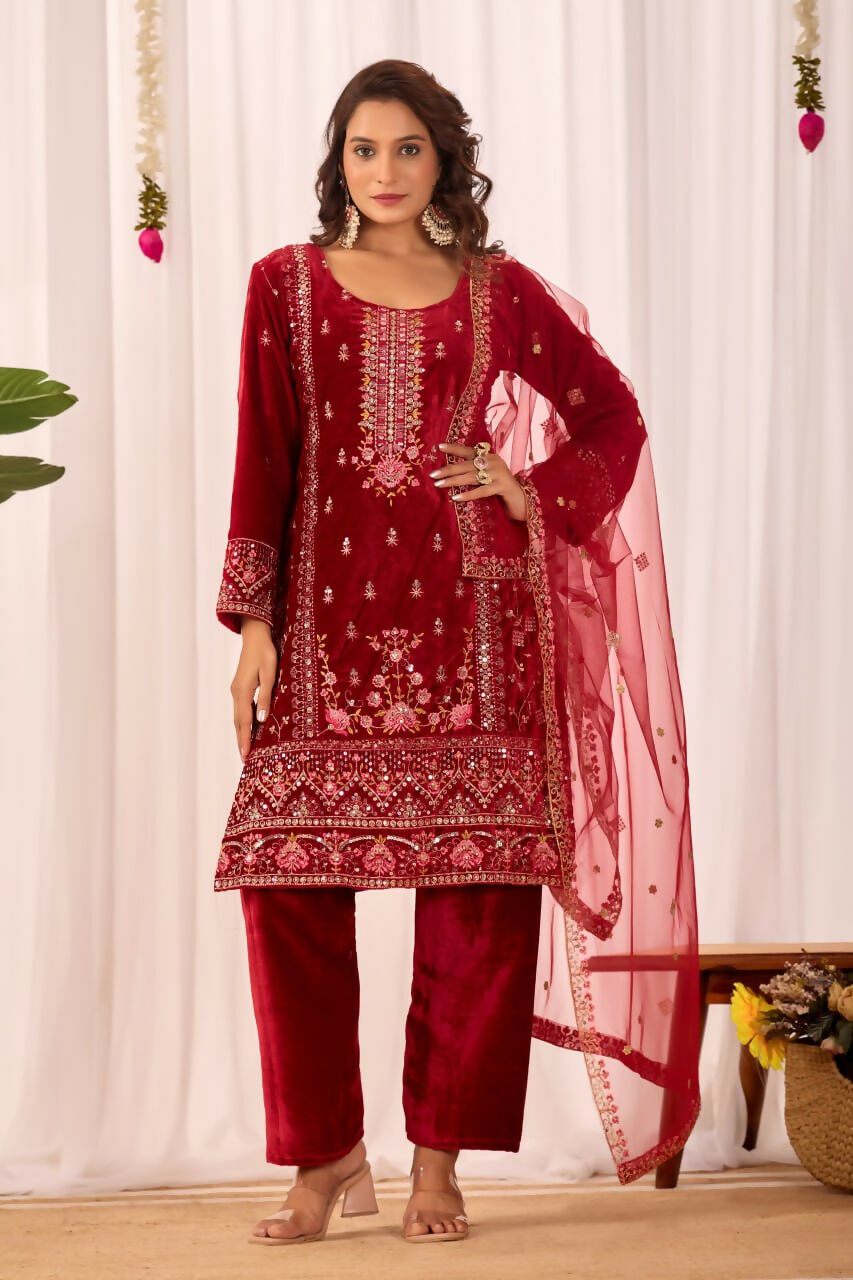 Model wearing a red velvet readymade kurta set with detailed embroidery and sequence work.
