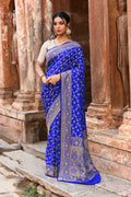Violet Banarasi silk saree with gold zari weave draped elegantly for a formal occasion.