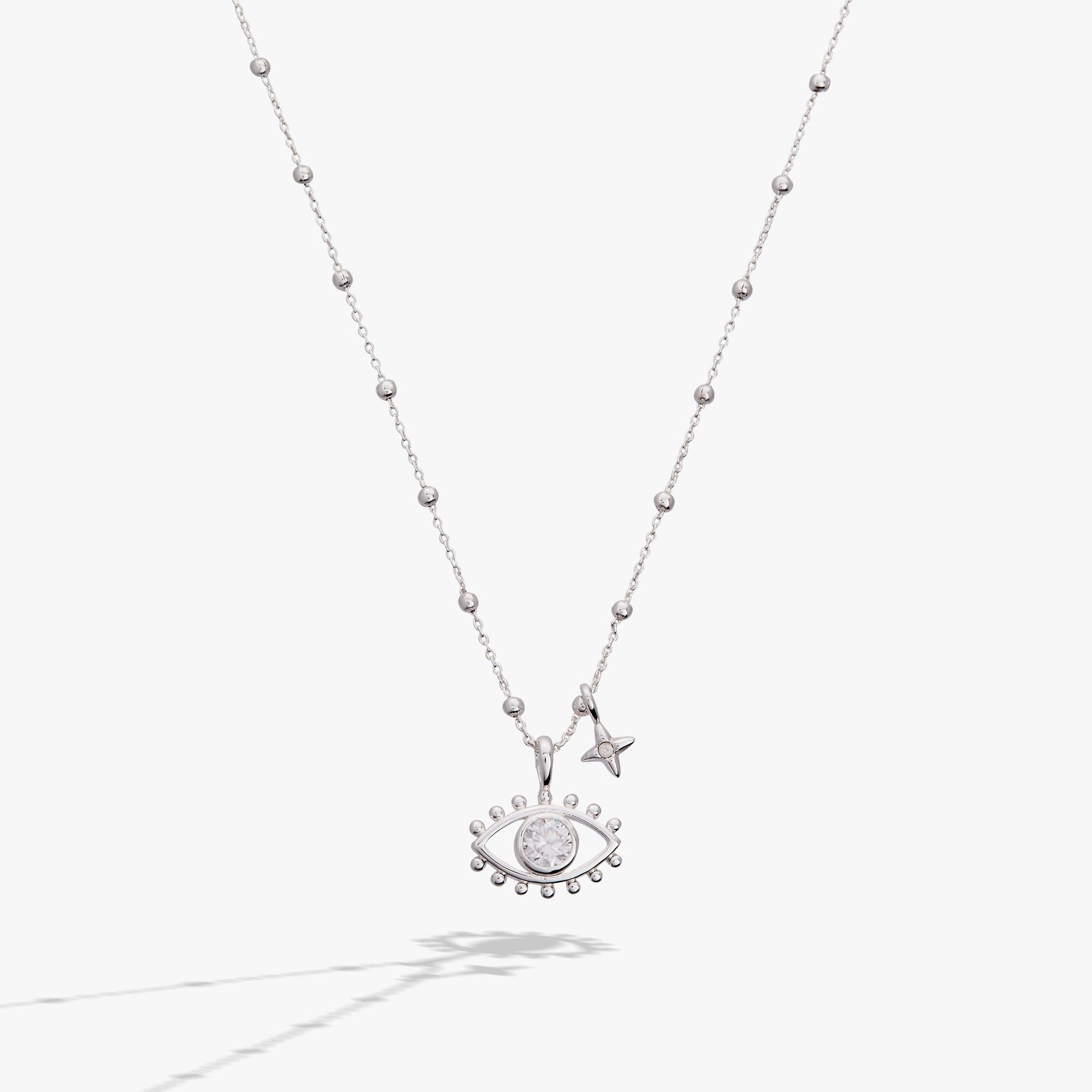 Minimalist Evil Eye Duo Charm Necklace featuring silver and white detailing.