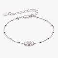 Silver-plated evil eye charm on a beaded chain bracelet