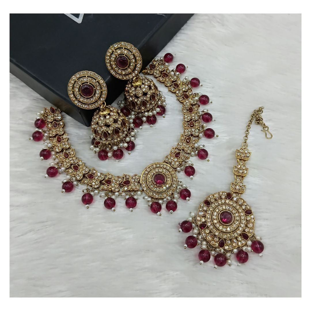 Stunning wine-colored stone work necklace set with matching earrings.