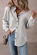 Women wearing a pinstripe button-down long shirt with tab sleeves in a relaxed fit