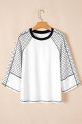 White long-sleeve top featuring black and white striped raglan sleeves and a solid white center panel on a hanger.