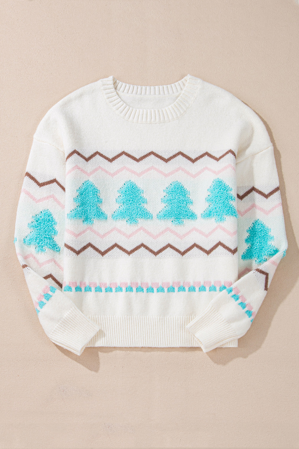 White long-sleeve sweater with a festive blue tree design and brown and pink chevron stripes, featuring ribbed collar and hem.