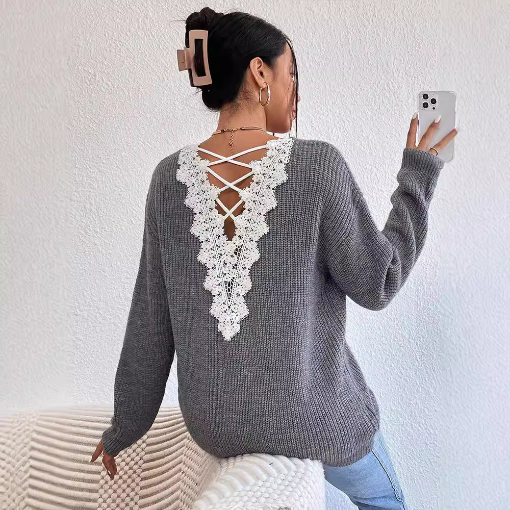 A woman wearing a stylish backless V-neck knit pullover sweater