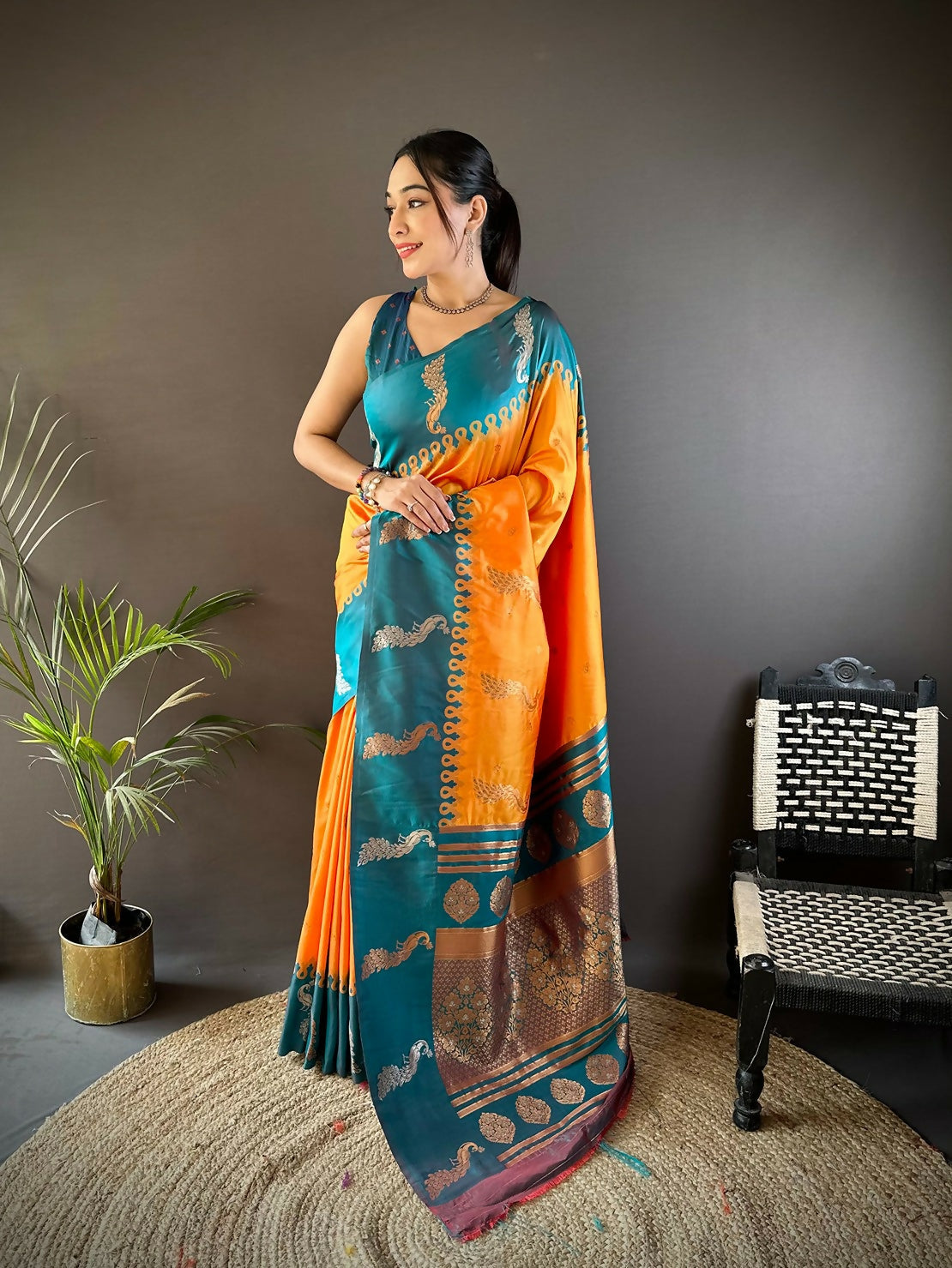 Teal silk saree with peacock and butti detailing, paired with unstitched blouse piece.