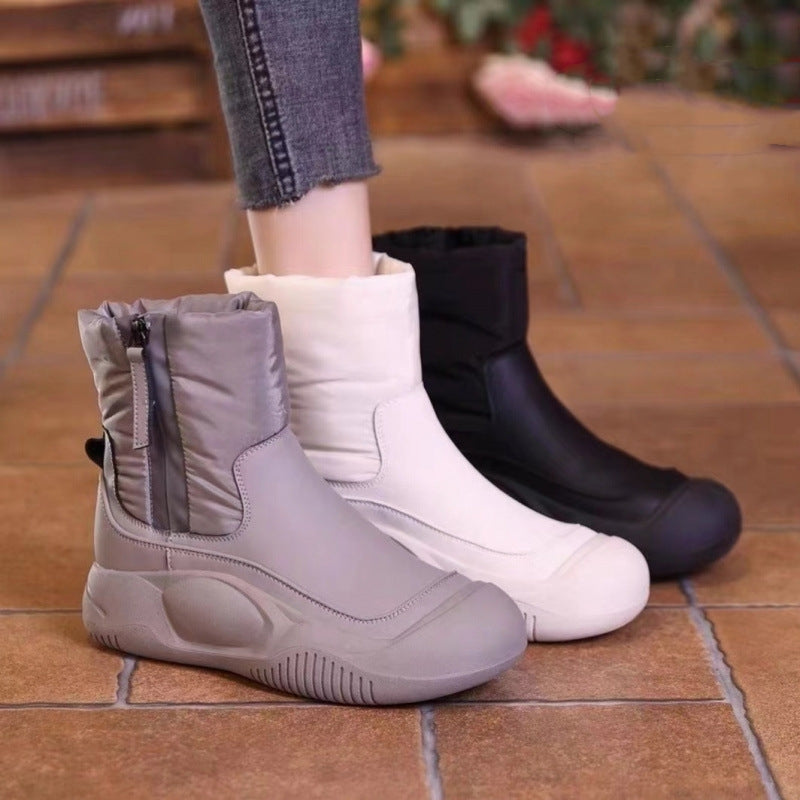Women wearing comfortable plush-lined side-zip snow boots in gray, white, and black
