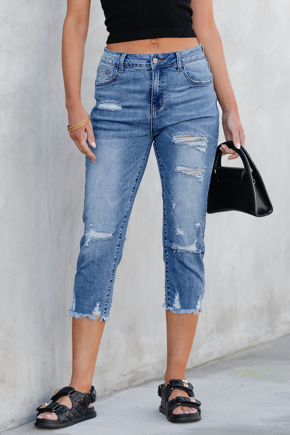 High-rise Georgia skinny distressed capri jeans in medium blue denim with zip-fly closure