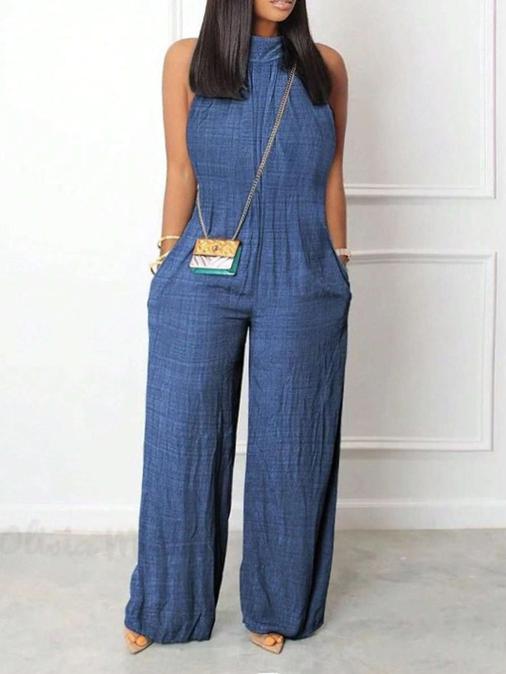 Sleeveless halter neck jumpsuit with ruffled details and flared hem in solid color