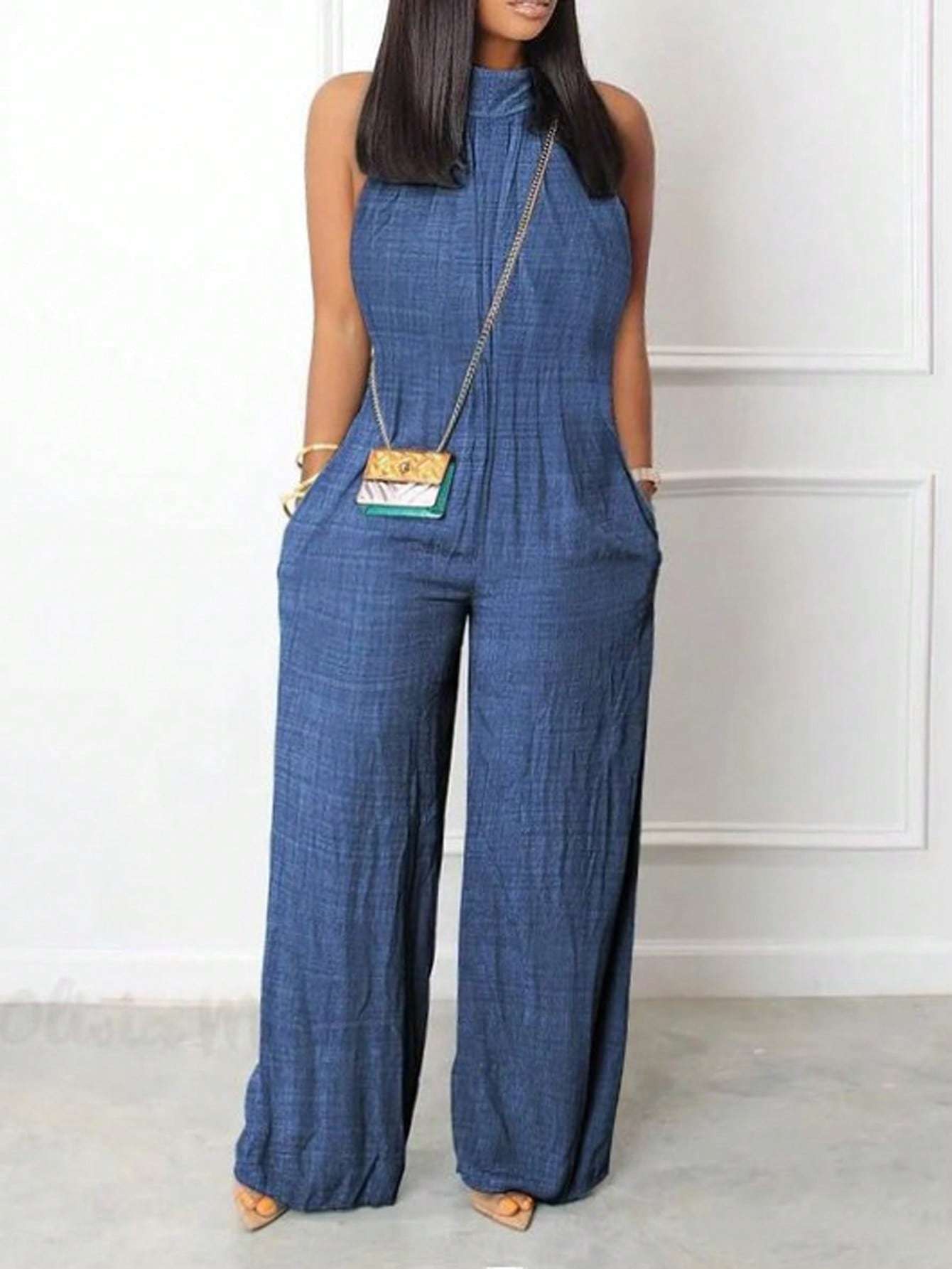Sleeveless halter neck jumpsuit with ruffled details and flared hem in solid color