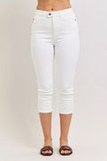 White capri pants worn by a person on a plain background