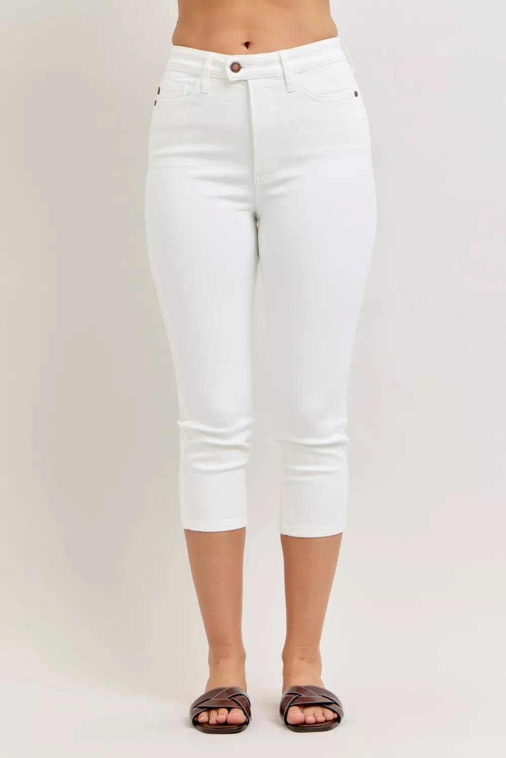 White capri pants worn by a person on a plain background