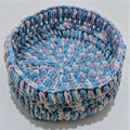 A clean, simple crochet basket designed for home organization, made from upcycled cotton t-shirt yarn.