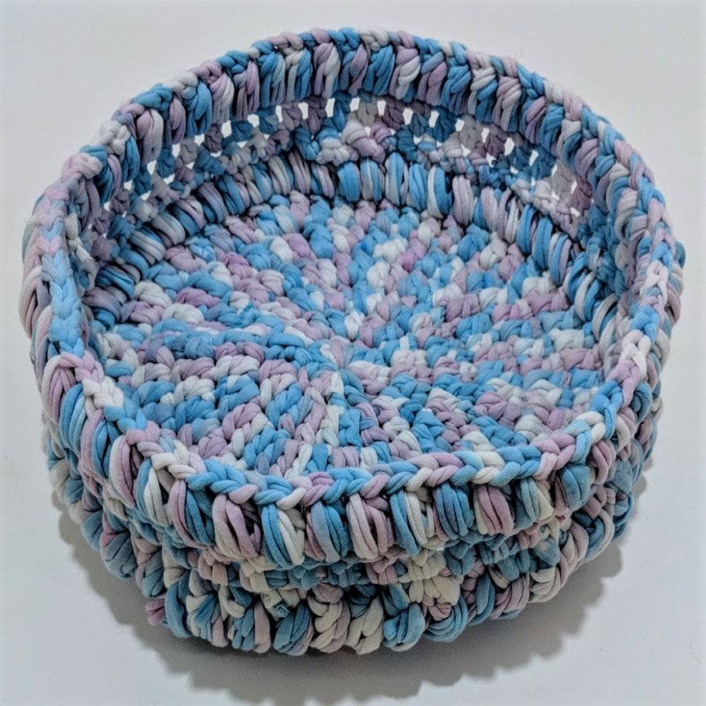 A clean, simple crochet basket designed for home organization, made from upcycled cotton t-shirt yarn.