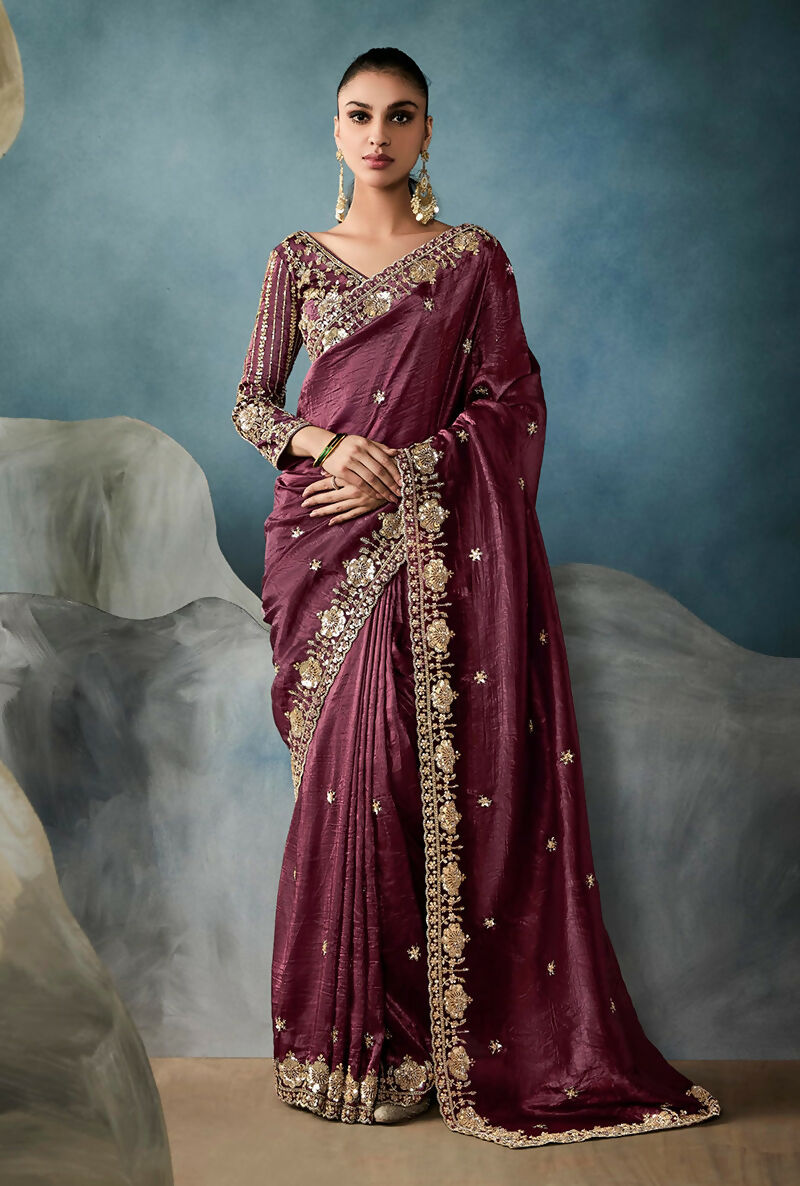Elegant wine tissue saree featuring intricate sequins and zari embroidery work.