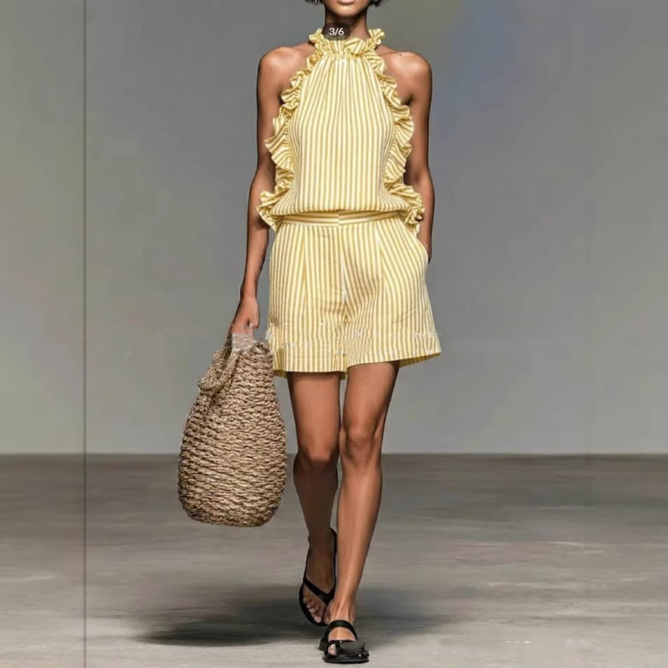 Model wearing a yellow and white striped ruffled sleeveless top and matching shorts set.