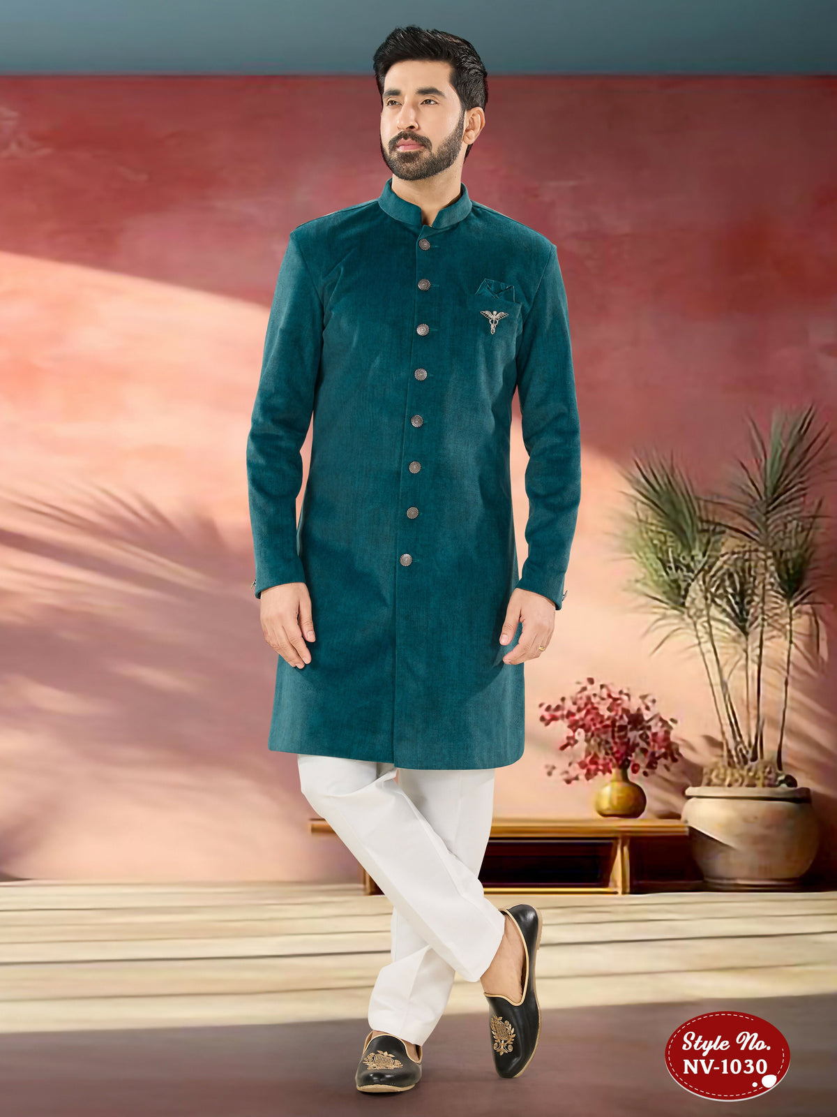 A man wearing a blue Swed Velvet Indo-Western Kurta with all-over thread and sequence embroidery.