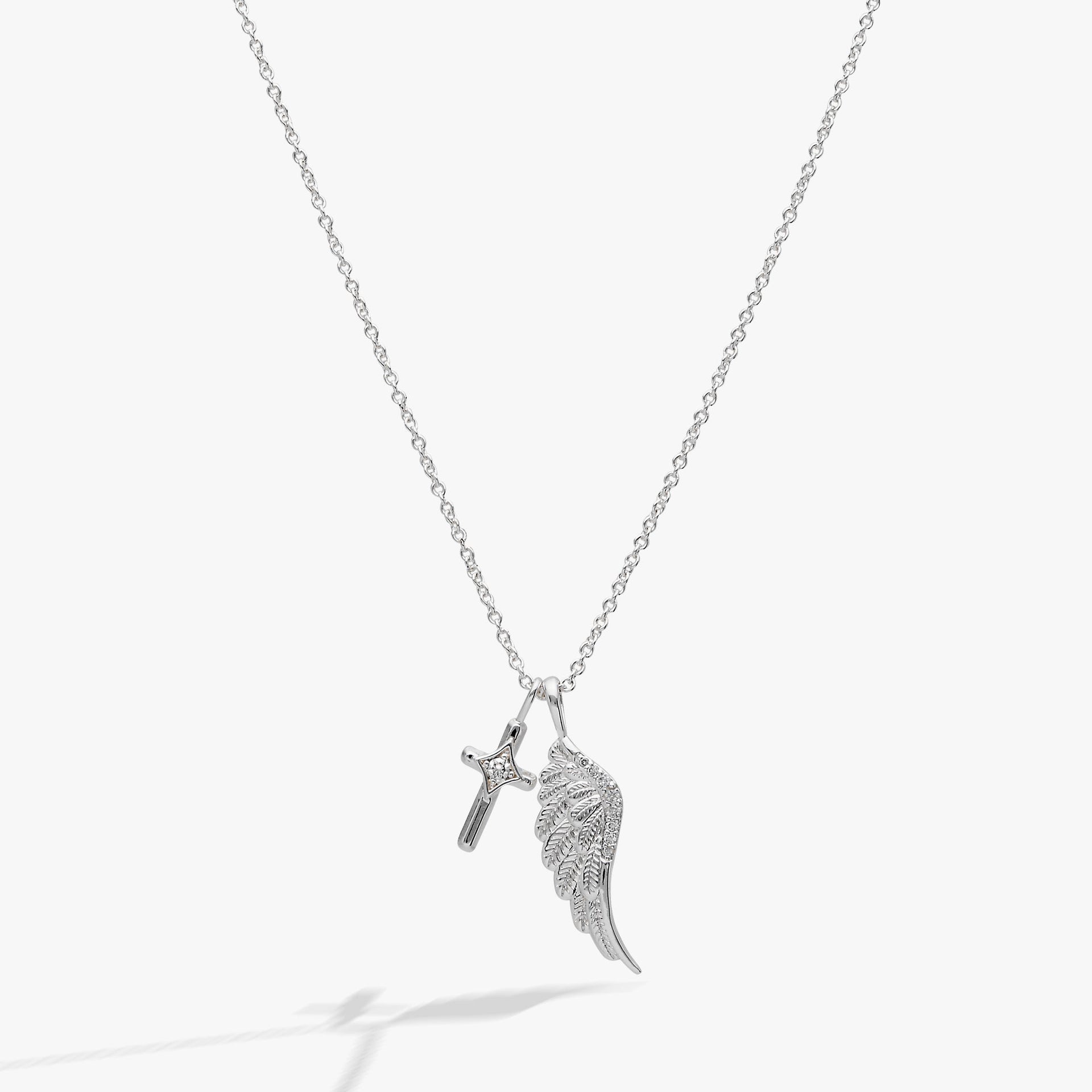 Silver-plated angel wing and cross charm necklace with crystal pave accents