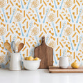 Farfalle wallpaper featuring whimsical gold, white, and light blue pattern on a kitchen wall.