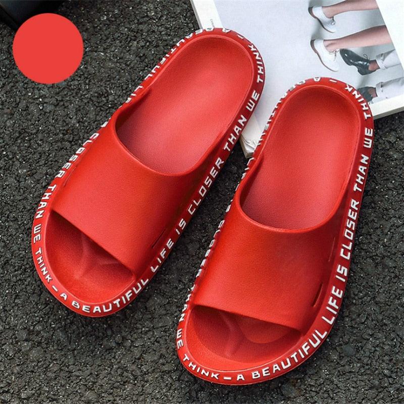 Pink massage shower slides with a diamond-shaped raised texture for foot relief