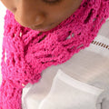 Close-up of a fashionable lacy skinny scarf made with silk yarn